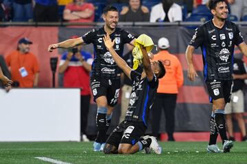 Players from Querétaro celebrate the goal they scored against the New England Revolution.